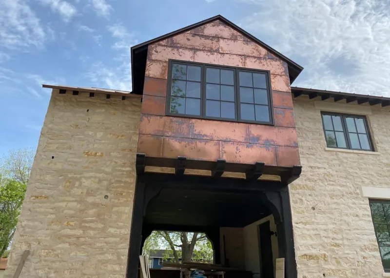 Copper metal panel facade on a stone building for Skylight Installation in Fond du Lac
